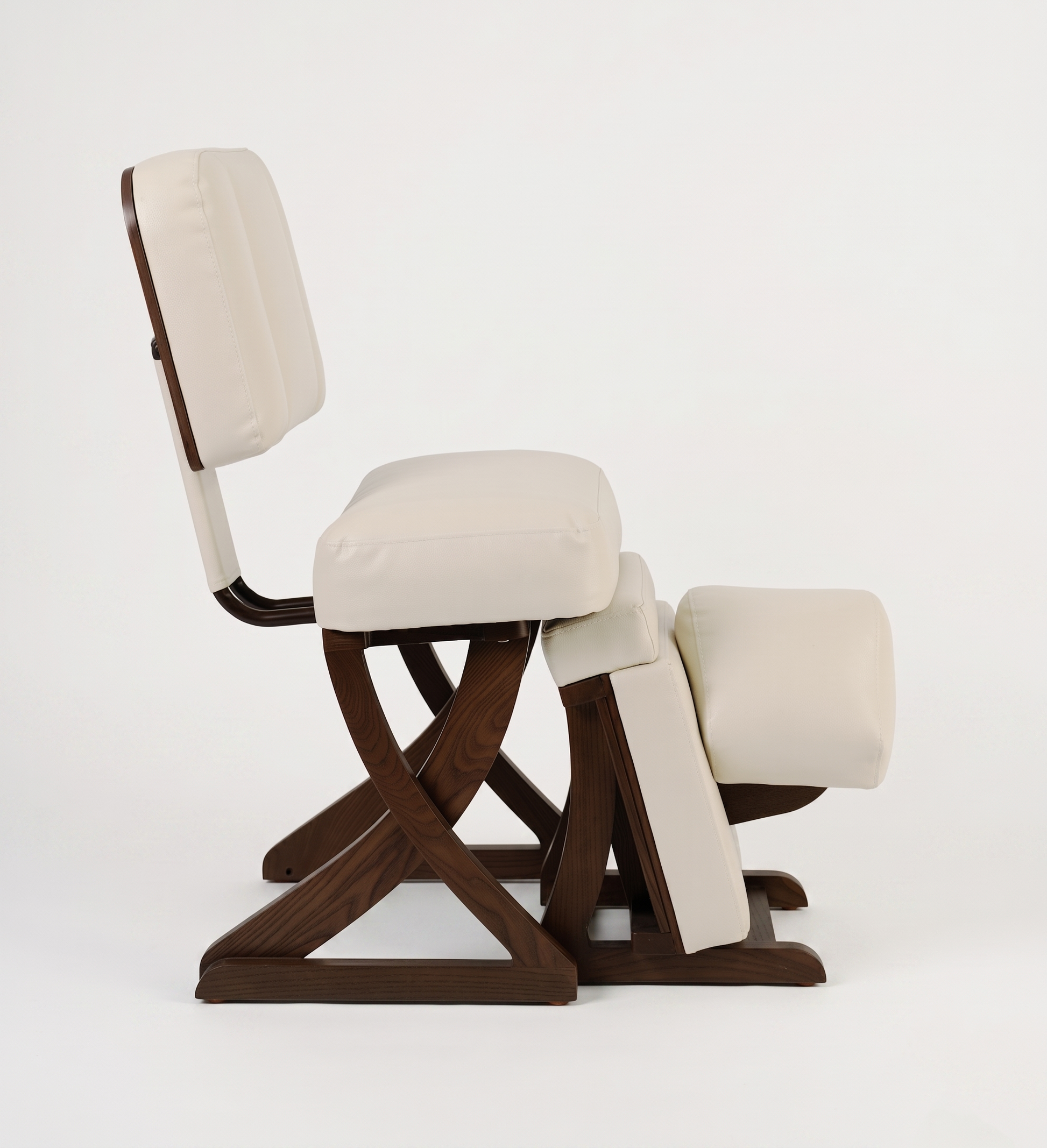 Kneeling chair with wooden frame and beige cushion on a white background
