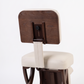 Meditation chair with wooden backrest and white cushion on a white background